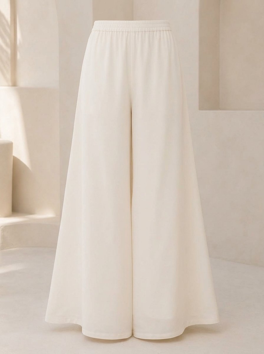 Woman wearing white sharara pants in dyeable cotton, waist-down view