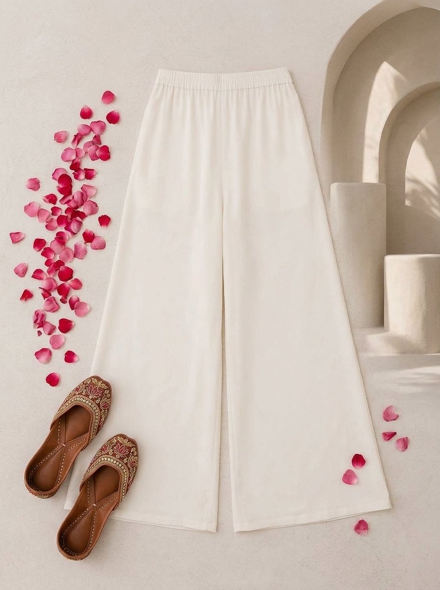 Woman wearing white sharara pants in dyeable cotton, waist-down view